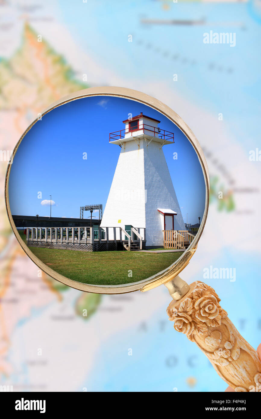 Looking in on a lighthouse in Atlantic Canada with blurred map in the background Stock Photo