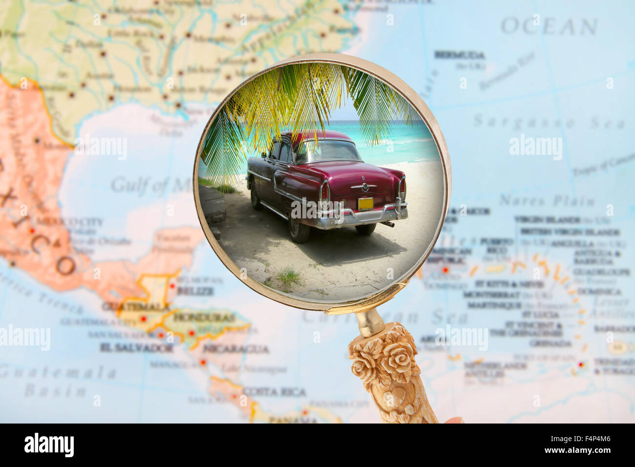 Looking in on a Cuban beach with old fashioned car with blurred Caribbean map in the background Stock Photo