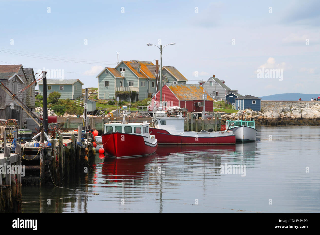 Coastal village of Peggys Cove, Nova Scotia, Canada, showing seaside shacks, fishing boats, and houses along the coast Stock Photo