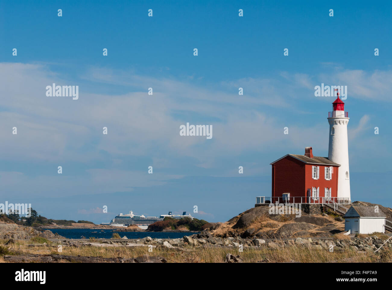Fisgard lighthouse, with cruise ship passing in the background, Victoria, British Columbia, Canada Stock Photo