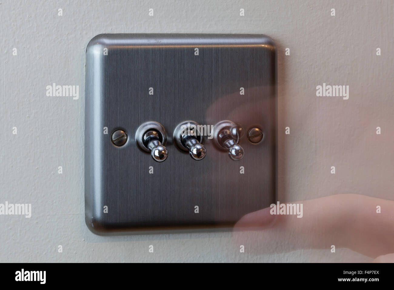 Turning the light switch on Stock Photo