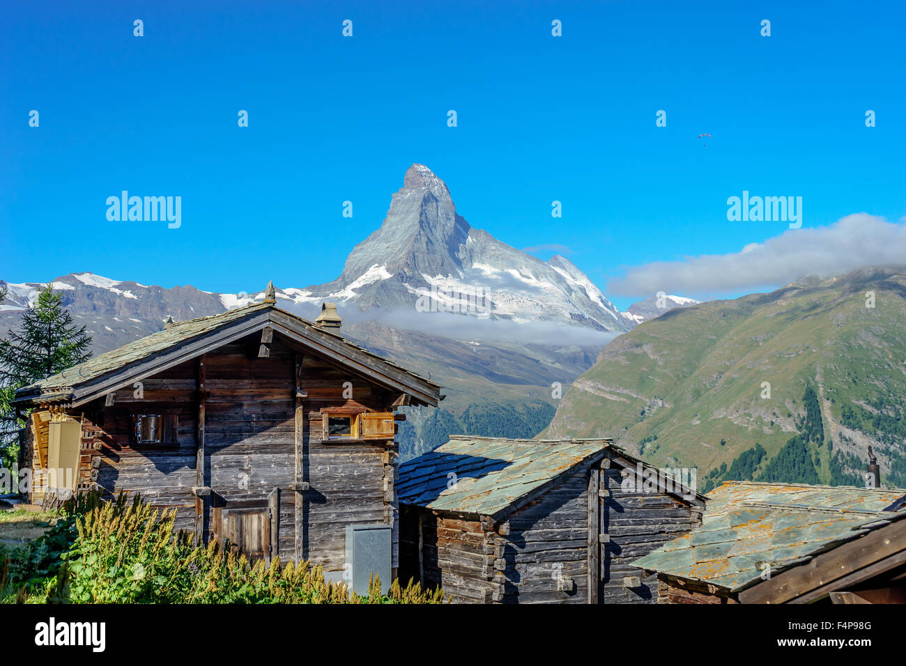 Cabins sit in a mountain village under the famous Matterhorn peak. July, 2015. Matterhorn, Switzerland. Stock Photo