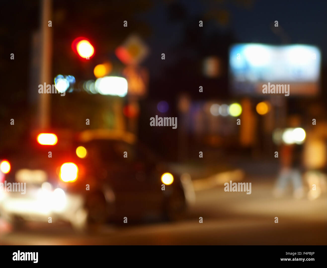 Abstract night scene with dim lights and headlights. Blur and defocused lights from the headlights of cars and traffic lights ca Stock Photo