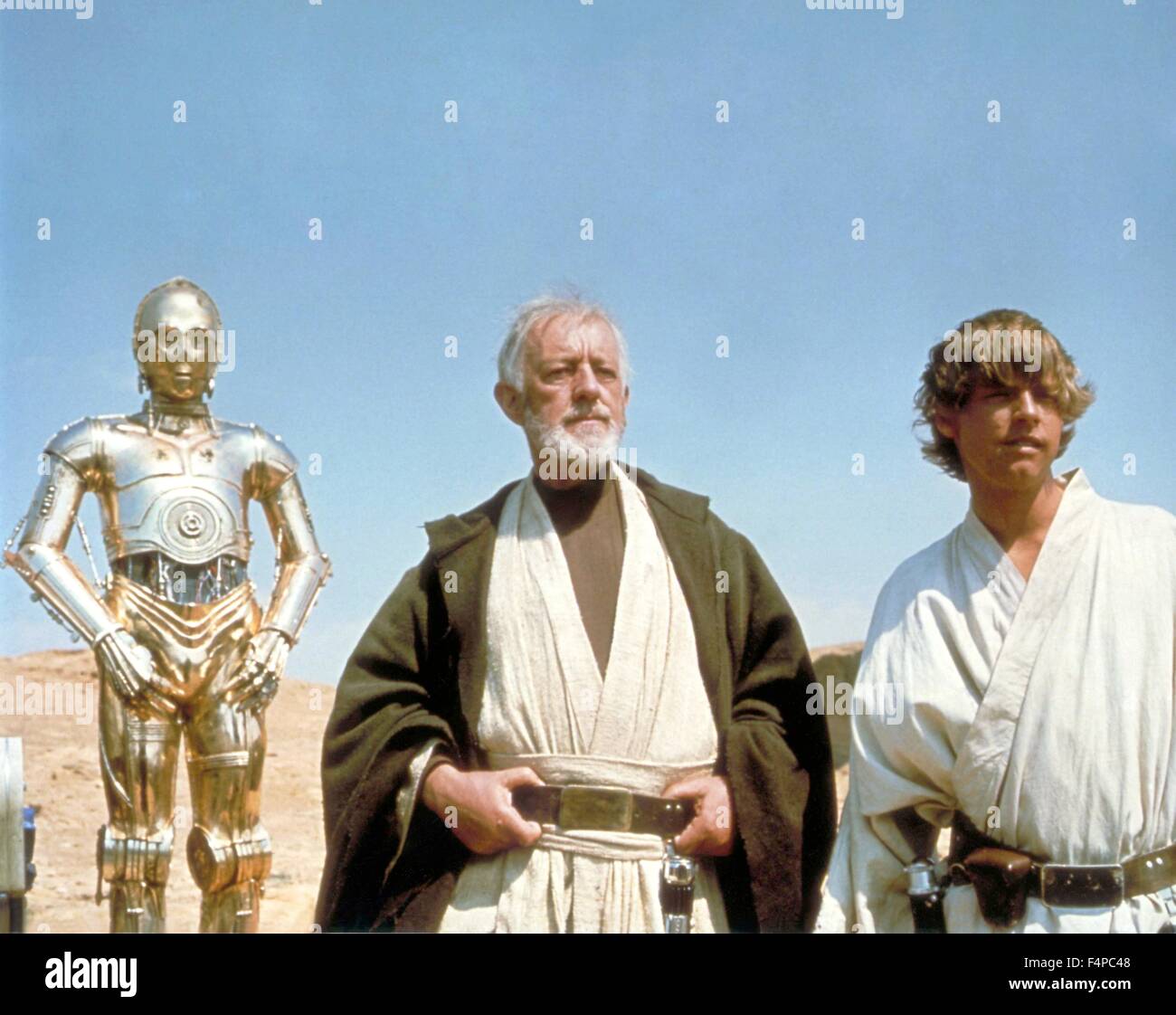 Anthony Daniels, Alec Guinness, Mark Hamill / Star Wars - A New Hope 1977 directed by George Lucas Stock Photo