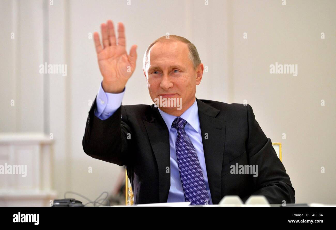 Russian President Vladimir Putin waves goodbye following a video conference with Argentine President Cristina Fernandez de Kirchner from the Kremlin October 21, 2015 in Moscow, Russia. Stock Photo