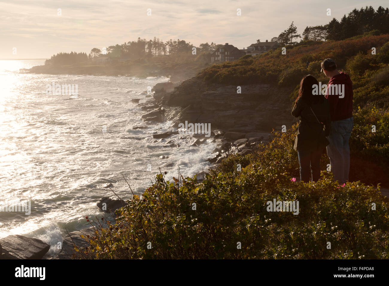 A couple at Cape Elizabeth on the Maine coastline at sunset, Cape Elizabeth, Maine USA Stock Photo