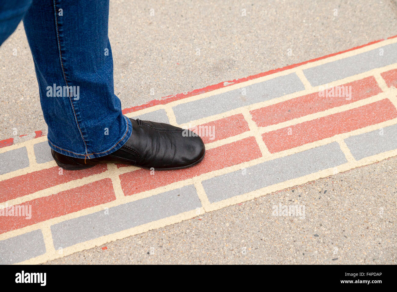 A tourist walking with her foot on the Boston Freedom Trail, Boston Massachusetts USA Stock Photo