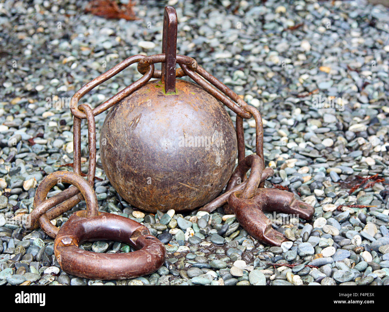 old ball and chain sitting on stones Stock Photo