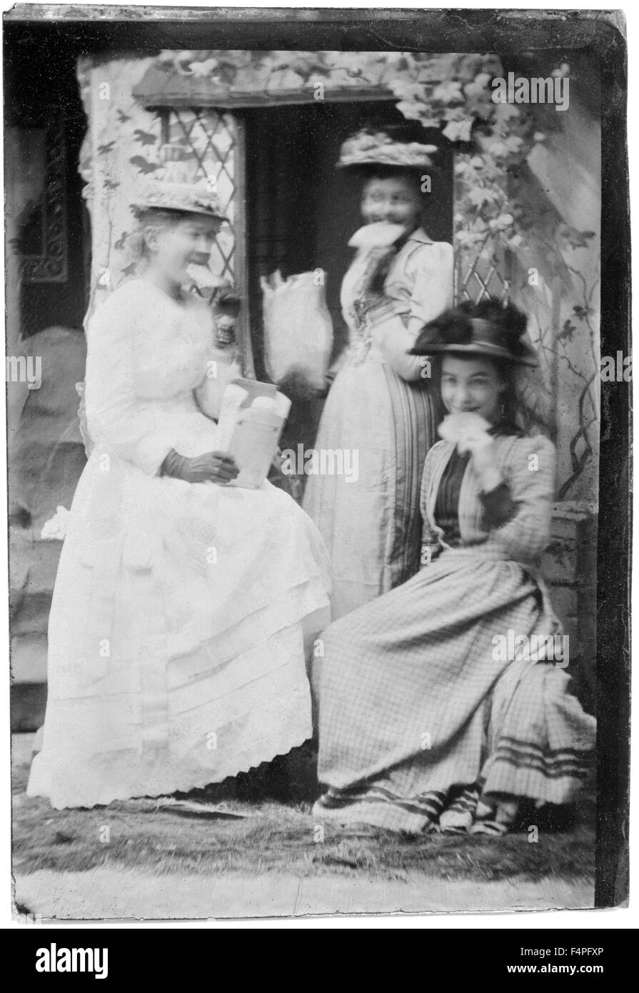 Portrait of Three Smiling Adult Women with Large Crackers in Mouths, circa 1870 Stock Photo