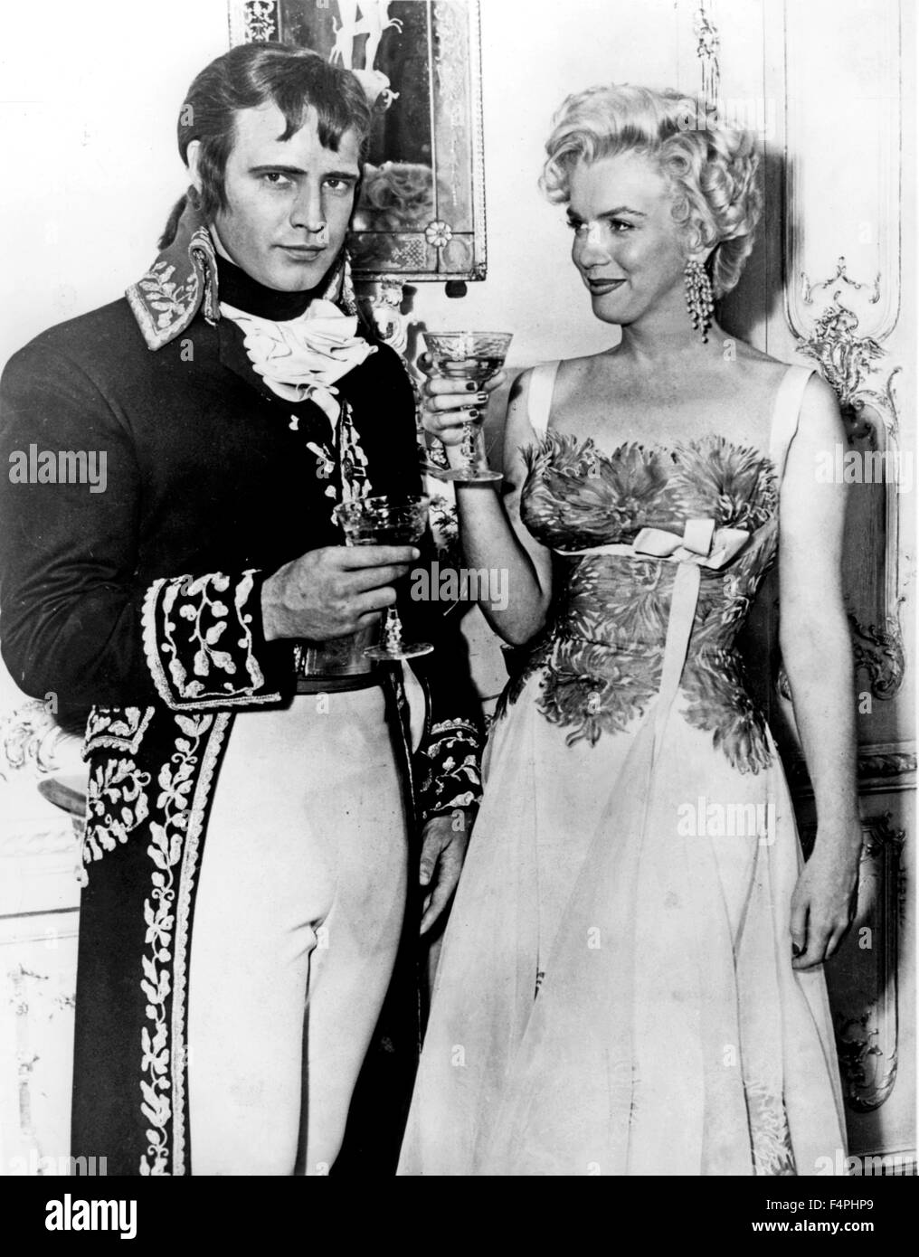 On the set, Marlon Brando plays Napoleon Bonaparte in the movie 'Desiree' directed by Henry Koster and Marilyn Monroe in 'There's No Business Like Show Business' directed by Walter Lang [20th Century Fox] Stock Photo