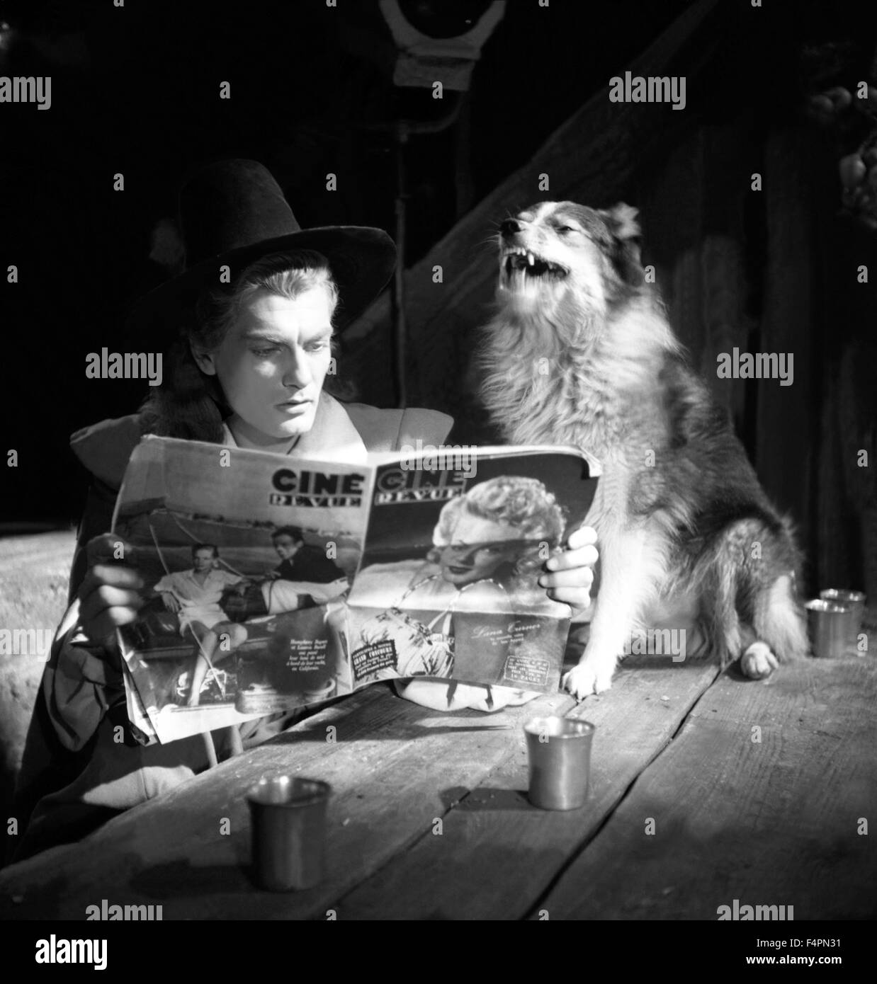 On the set, Jean Marais and his dog / Beauty and the Beast / 1946 directed by Jean Cocteau Stock