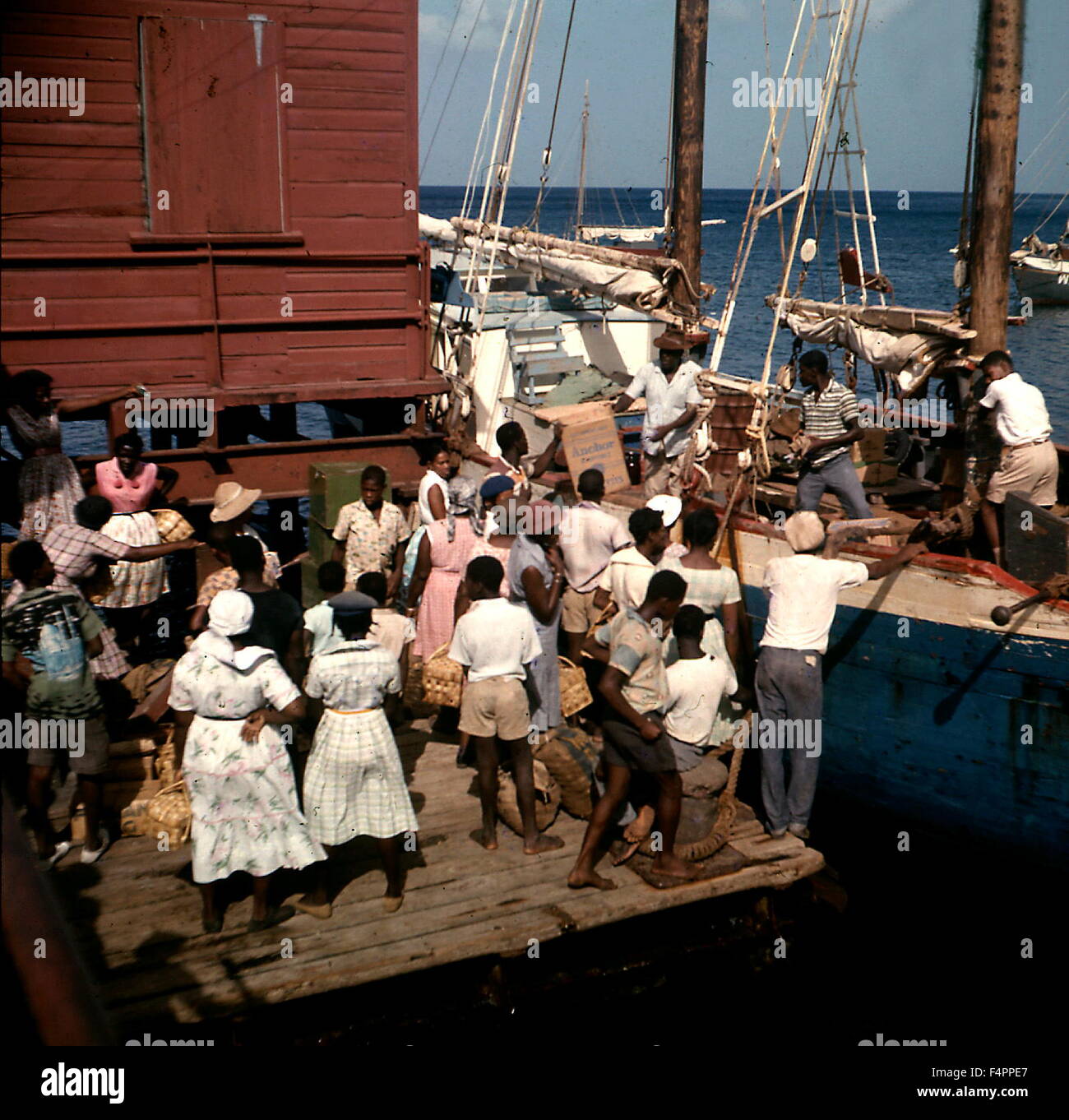 AJAXNETPHOTO. 1958. KINGSTOWN, ST.VINCENT, WEST INDIES.  - INTER ISLAND SHIPMENT OF GOODS ARRIVES - UNLOADING A SCHOONER. LIFE IN THE CARIBBEAN IN THE 1950S AND 60S.   PHOTO: REG CALVERT/AJAX   ©AJAX NEWS & FEATURE SERVICE/REG CALVERT COLLECTION   REF:RC07. Stock Photo