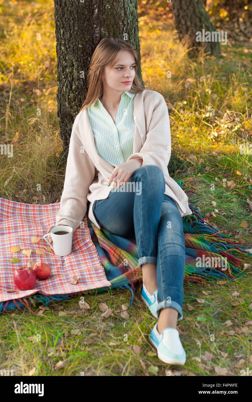 Young beautiful girl relaxing in the autumn park Stock Photo - Alamy