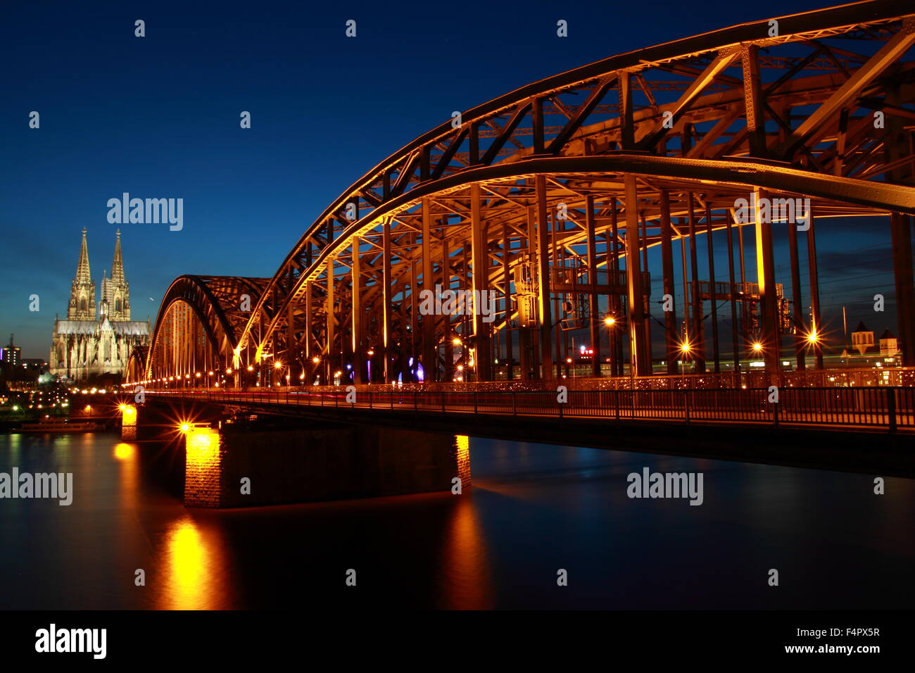 Hohenzollern Bridge and Cologne Cathedral at dusk in Cologne, Germany. Stock Photo