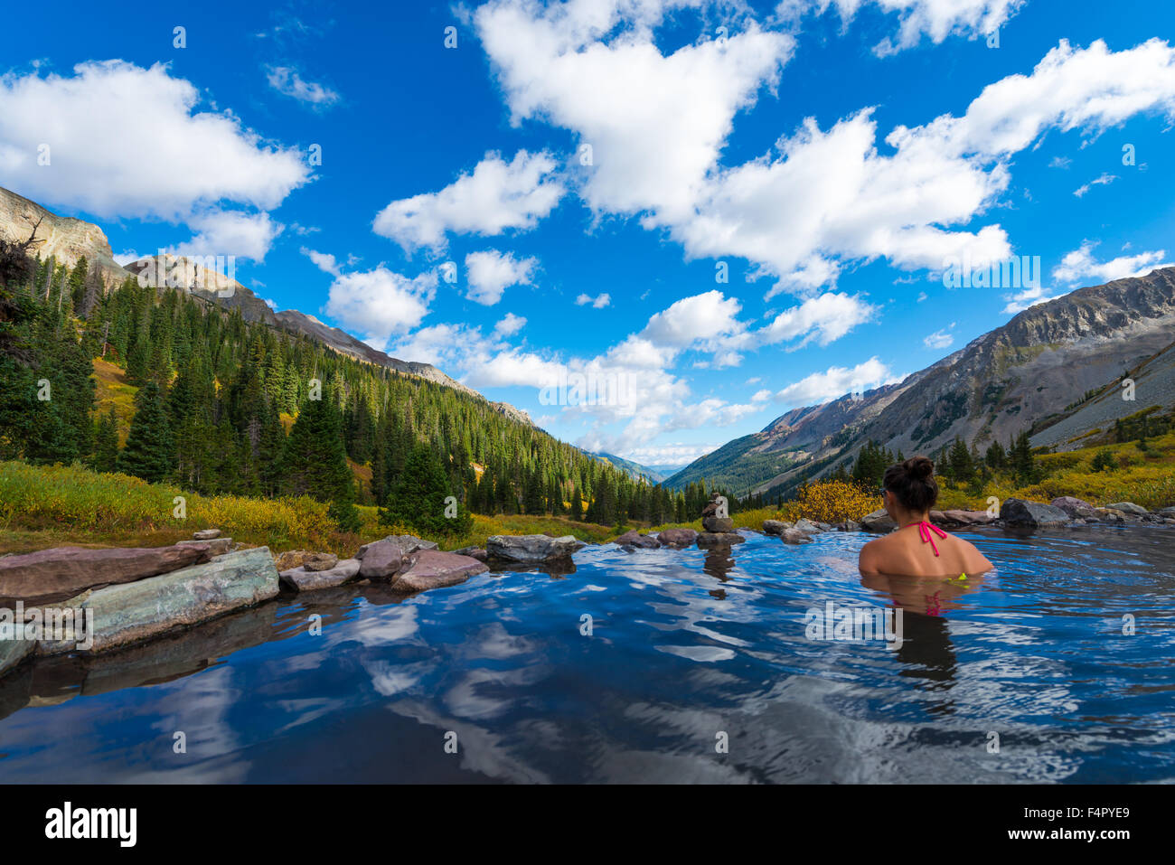 Woman relaxing in hot spring pool Conundrum Hot Springs near Aspen