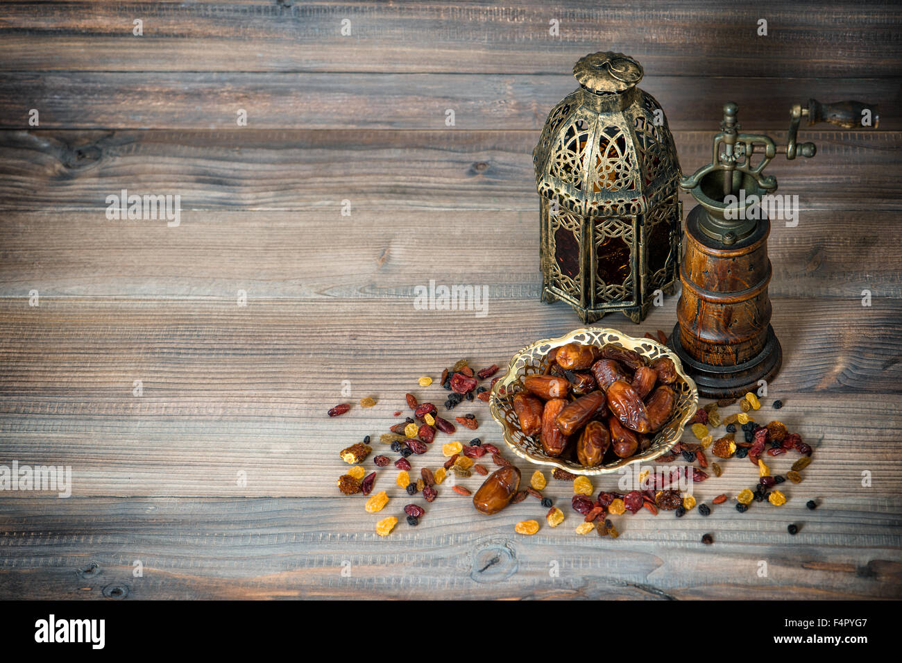 Raisins and dates on wooden background. Arabic till life with vintage