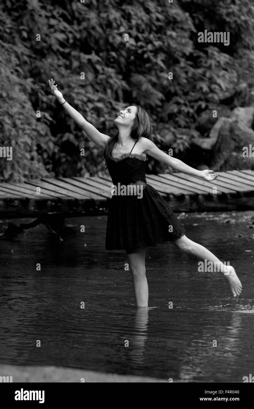 Beautiful young woman posing in a lake forest Stock Photo