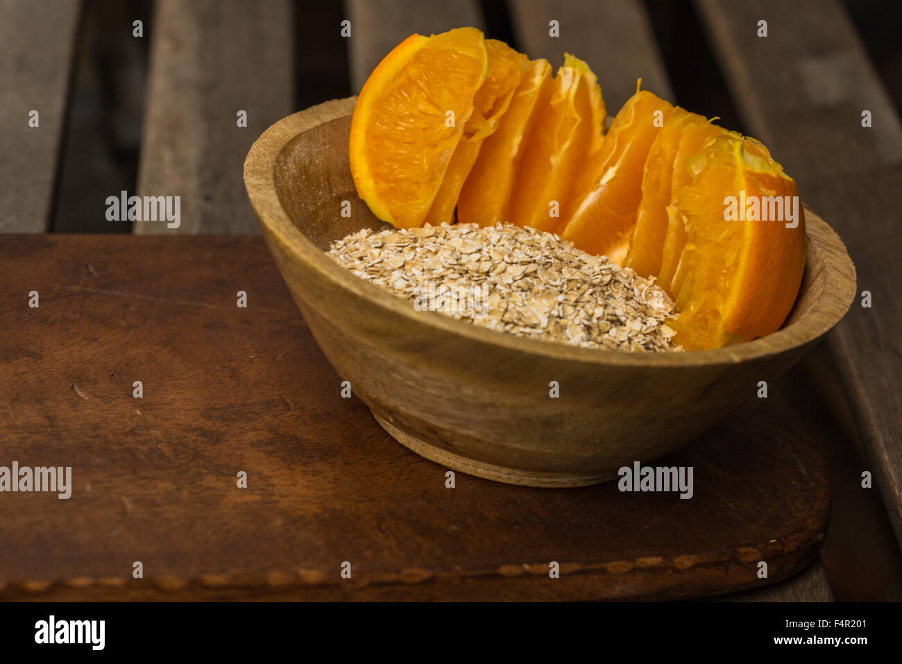 Oatmeal and orange in a bowl for healthy breakfast - food synergy, add water or    . Stock Photo