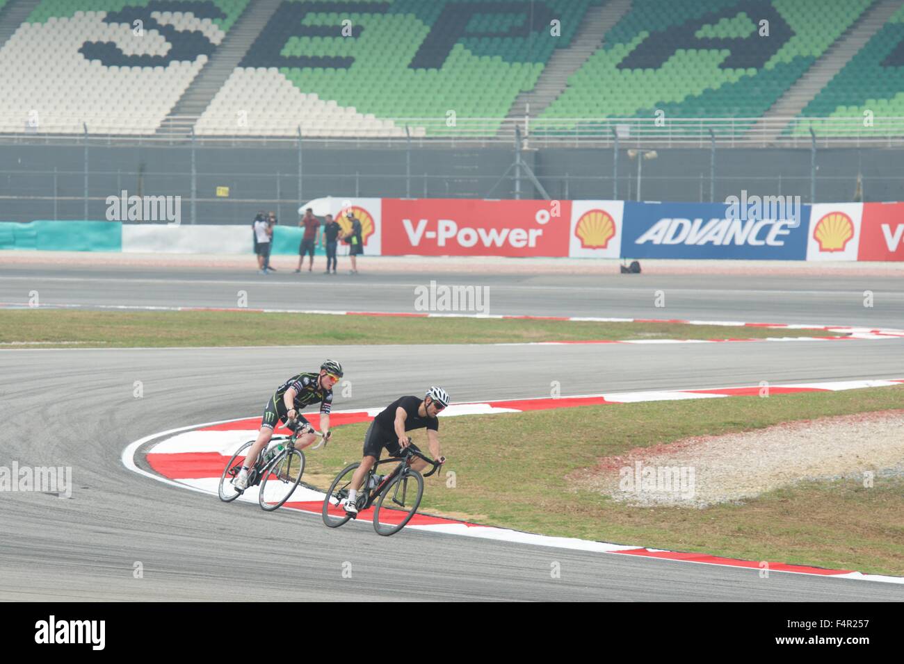 Sepang Circuit, Malaysia. 22nd Oct, 2015.  Bradley Smith and Cal Crutchlow ride Sepang Circuit on their bicycles before the Malaysian Motorcycle Grand Prix Credit:  Tom Morgan/Alamy Live News Stock Photo