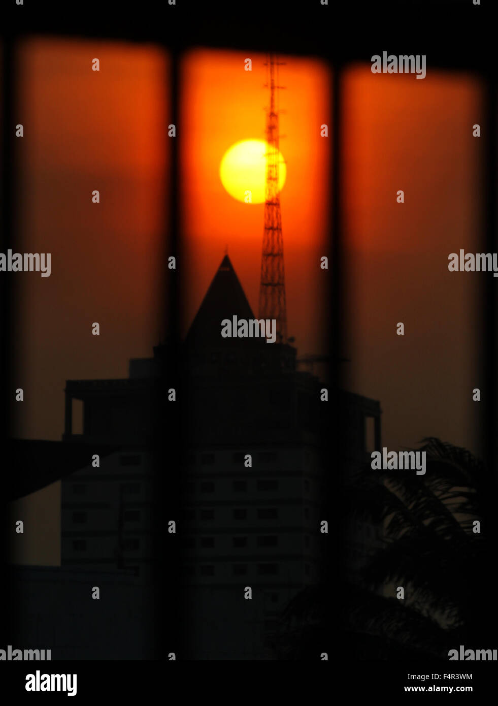 Views of the sun between buildings in the city of Jakarta, Indonesia Stock Photo