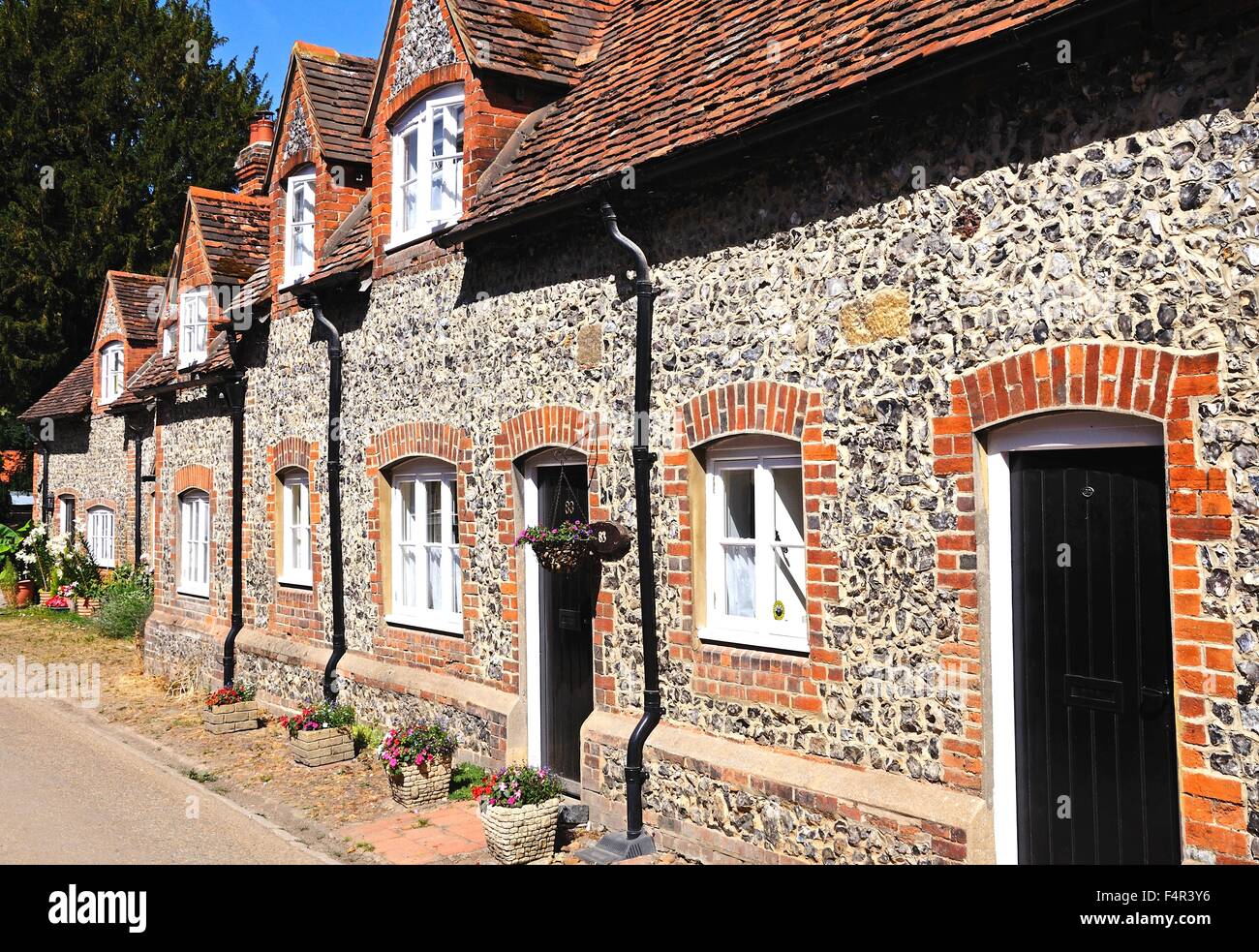 Pretty brick and flint cottages with dormer windows along a village