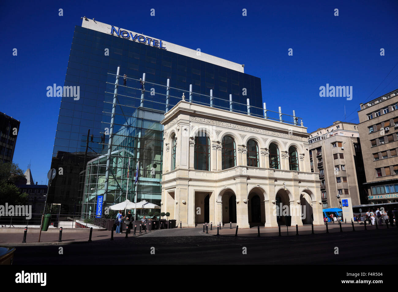 Hotel Novotel, modern glass facade building behind the facade of a historic house Stock Photo