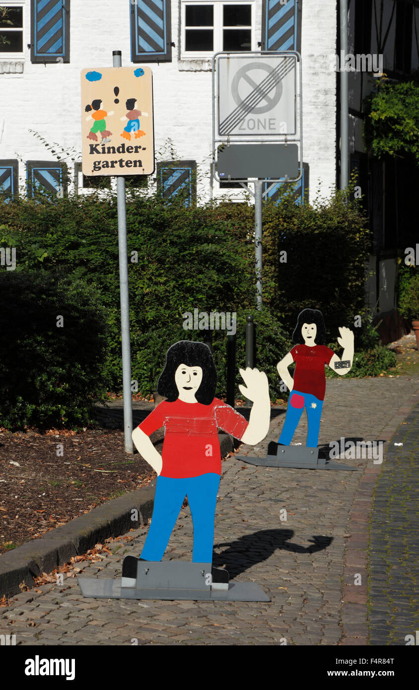 attention sign to car drivers and road users, direction sign of a kindergarten, children cardboard cut-off Stock Photo