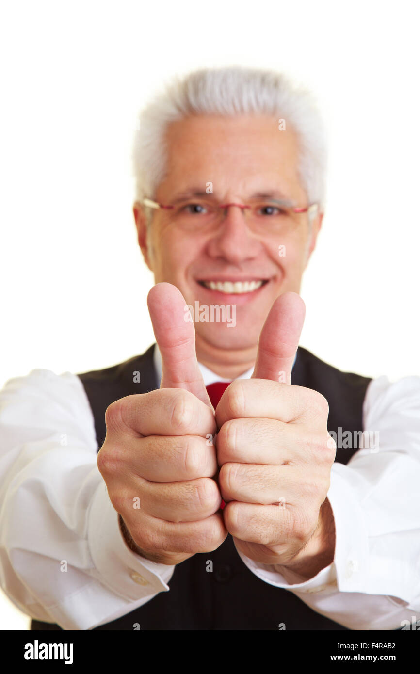 Happy elderly businessman holding his thumbs up Stock Photo - Alamy