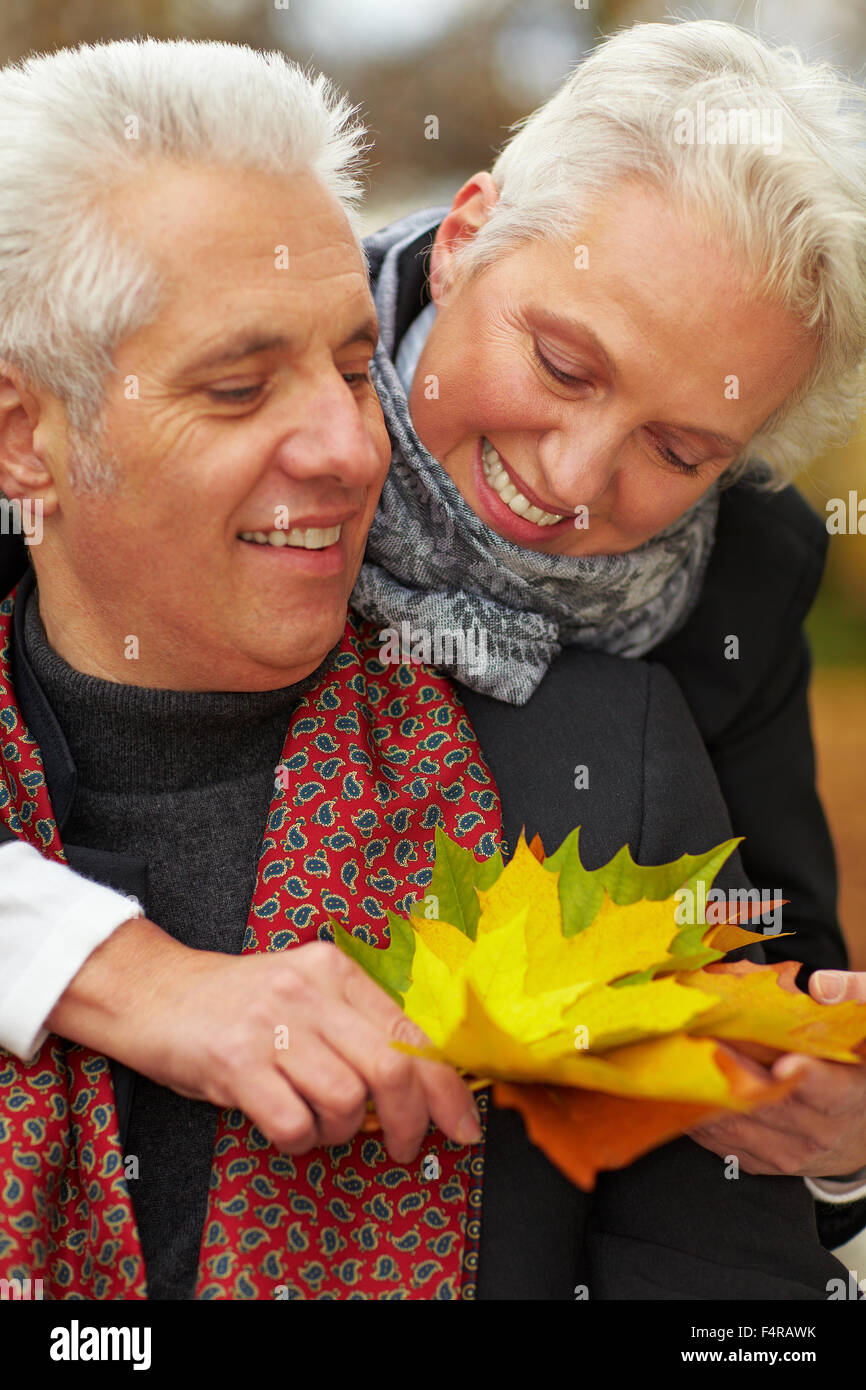 Happy senior couple in an autumn forest Stock Photo - Alamy