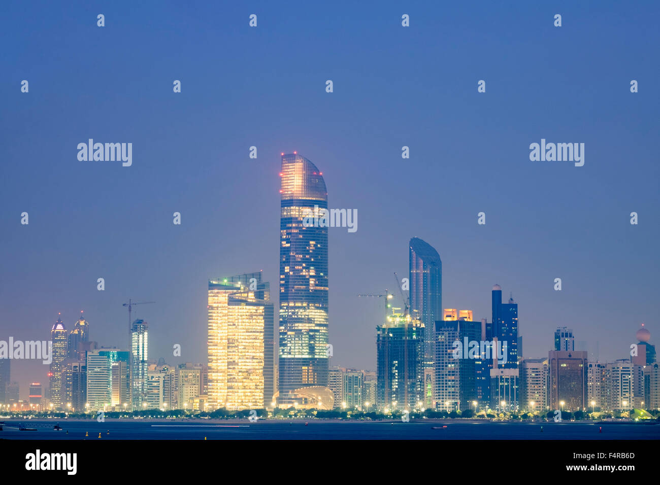 Skyline Of Modern Skyscrapers At Night Along Corniche In Abu Dhabi