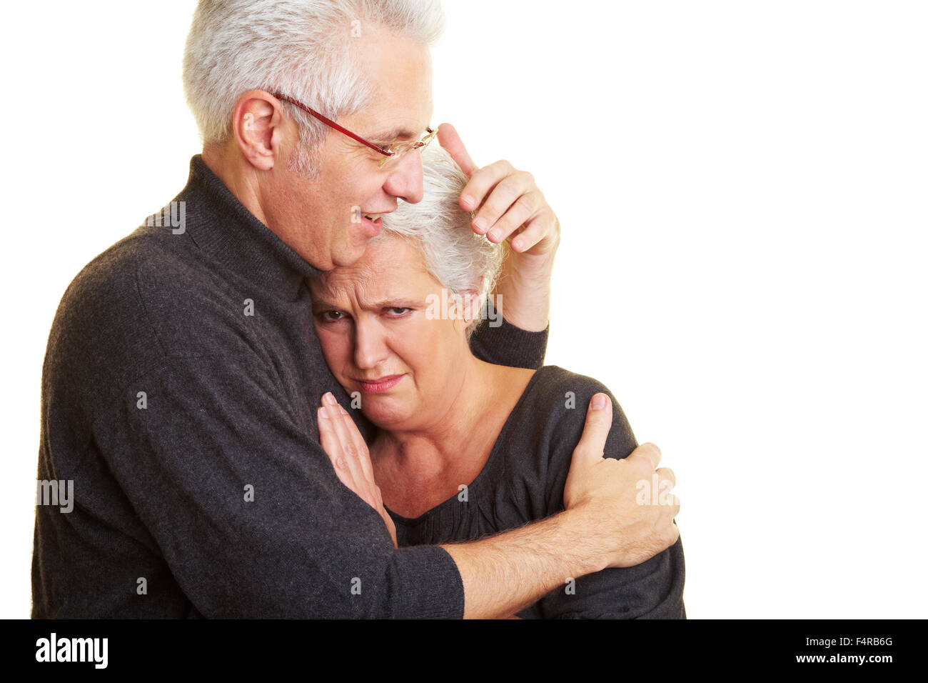 An elderly man comforting his sad wife Stock Photo