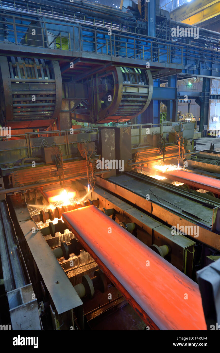 cut hot steel on conveyor inside of steel plant Stock Photo
