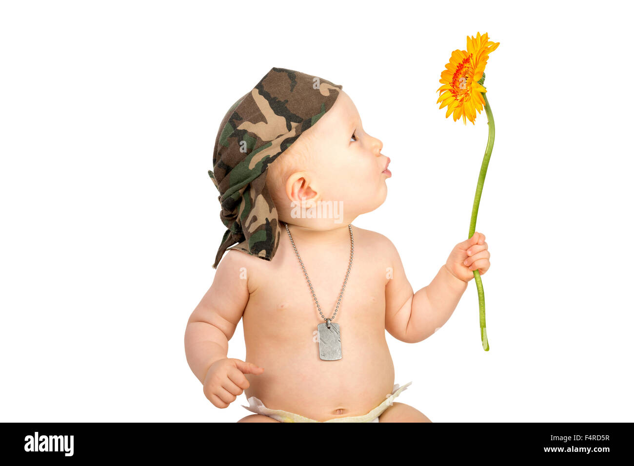 Cute baby girl soldier with flower Stock Photo