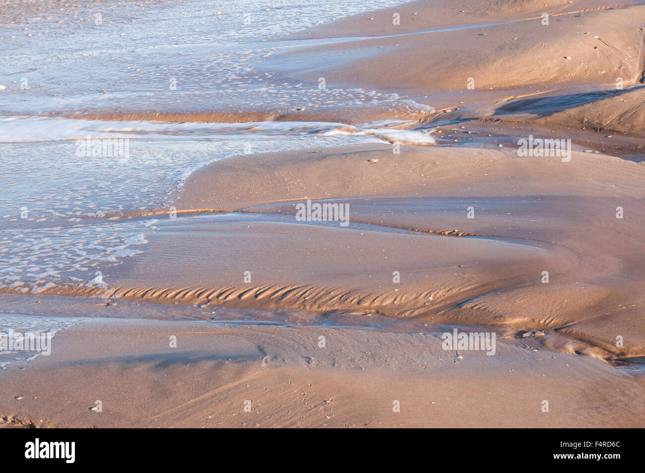 water flowing back from the beach Stock Photo