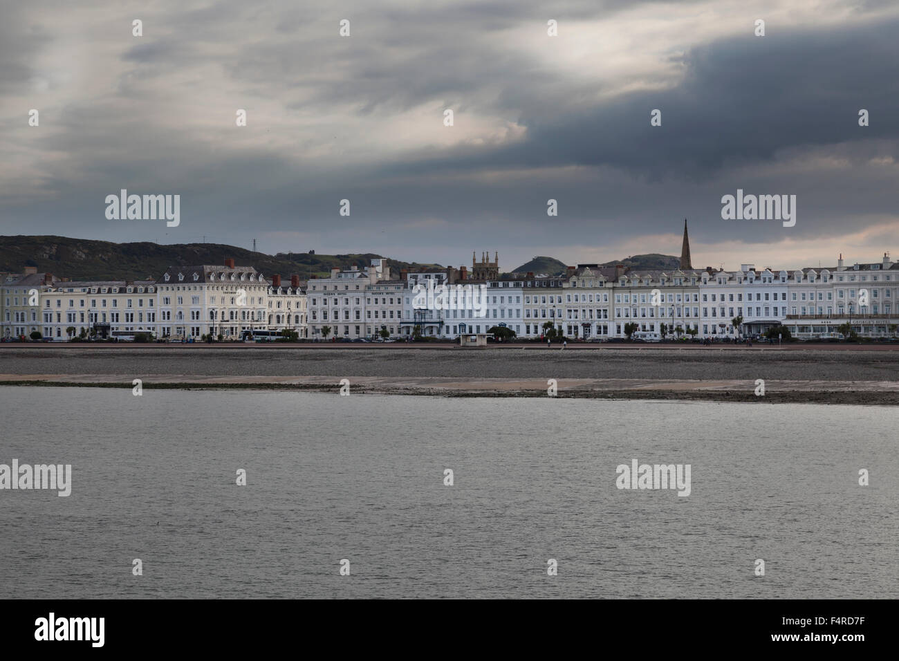 View of moody skies from pier across to Llandudno 's sea front hotels Stock Photo