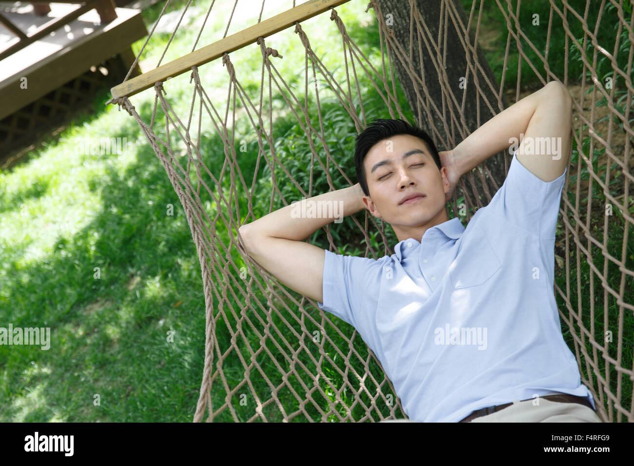 The young man is sleeping in a hammock Stock Photo