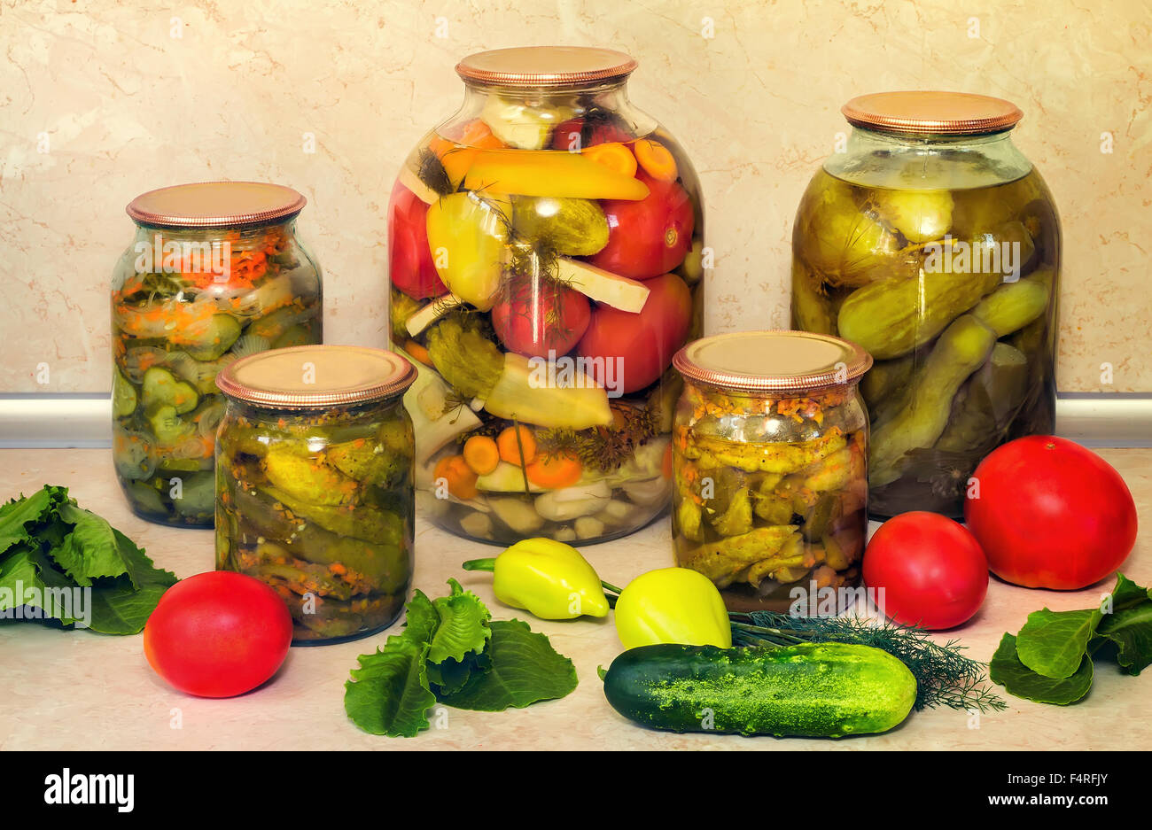 Home canning jars with canned along with carrots and spices cucumbers