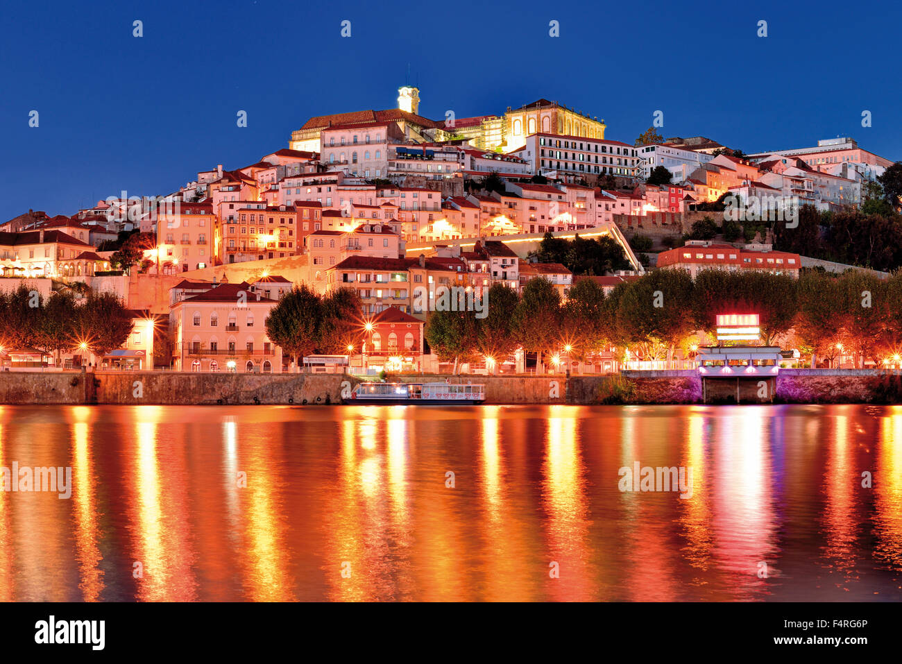 Portugal: Nocturnal view to the university town Coimbra above river Mondego Stock Photo