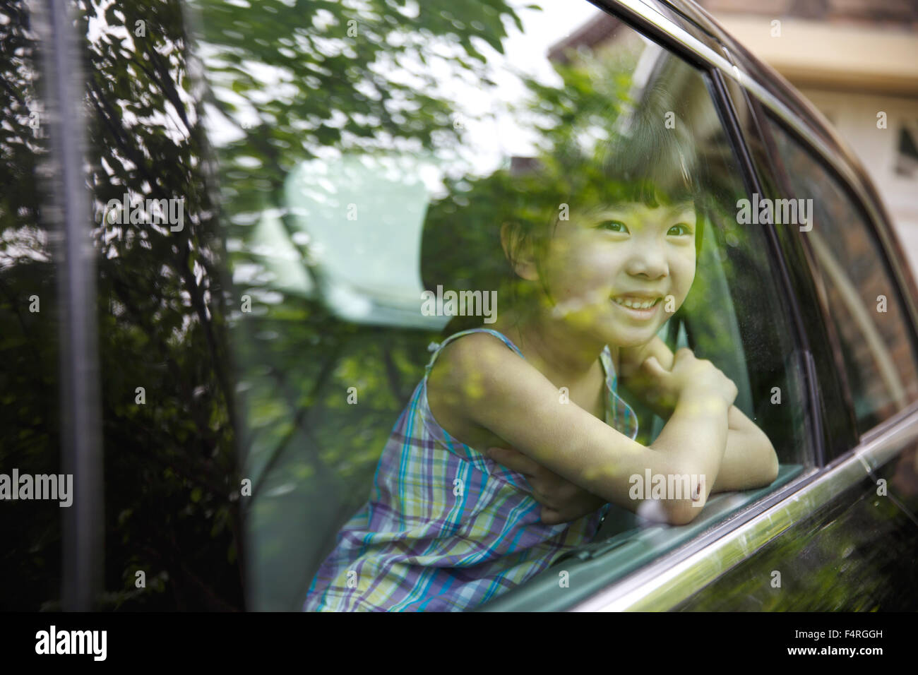 Happy little girl sitting in the car Stock Photo - Alamy