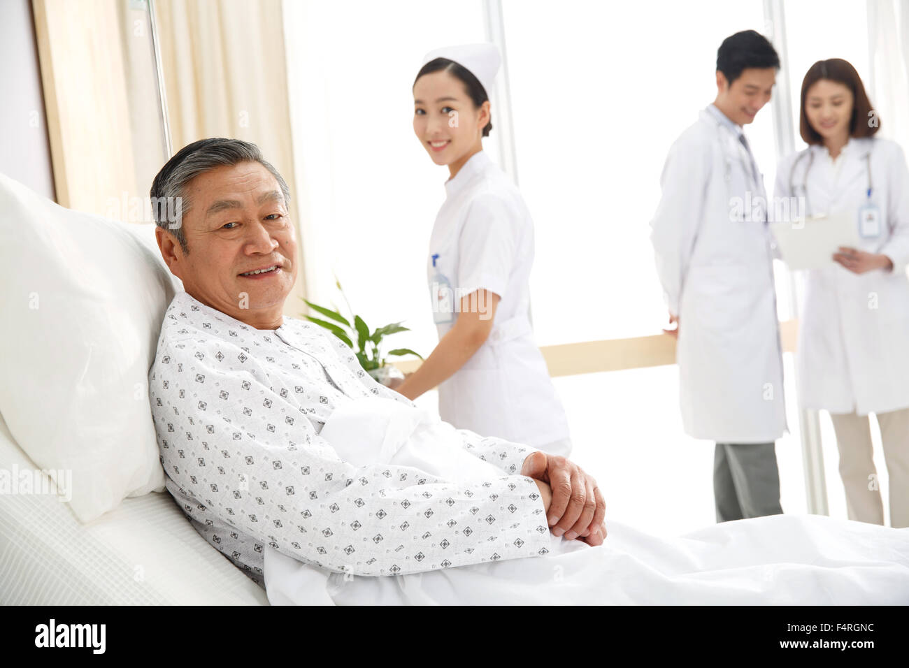 Medical workers and patients in the ward Stock Photo