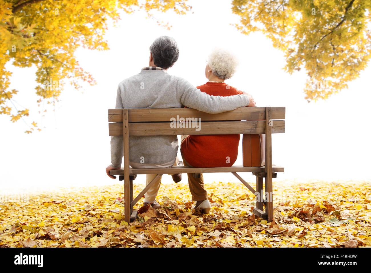 Happy old couple sitting on a bench Stock Photo - Alamy
