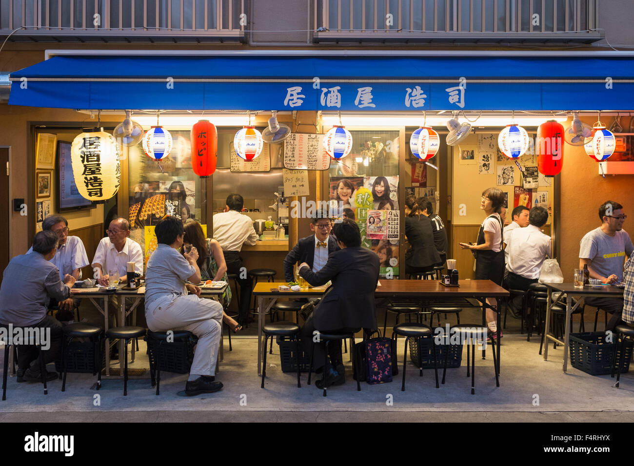 Small outdoor restaurant on street in the evening in Rokku entertainment district of Asakusa adjacent to SensoJi shrine in Tokyo Stock Photo