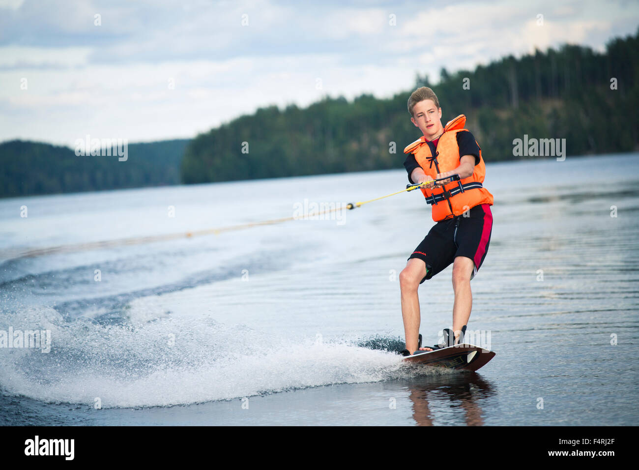 Sweden, Ostergotland, Lake Risten, Teenage boy (14-15) wakeboarding Stock Photo