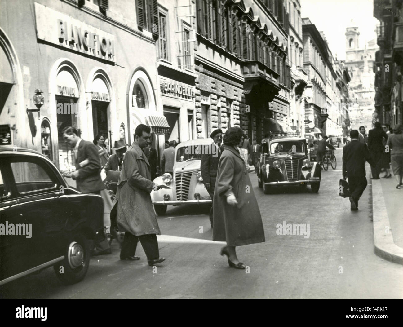 Cars and passers-by in Via dei Condotti, Rome, Italy Stock Photo