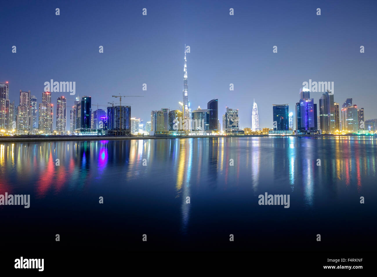 Night view of Burj Khalifa and Creek at new Business Bay district of Dubai United Arab Emirates Stock Photo