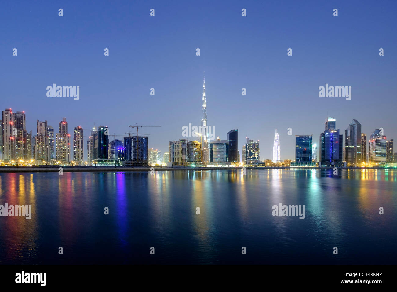 Night view of Burj Khalifa and Creek at new Business Bay district of  Dubai United Arab Emirates Stock Photo