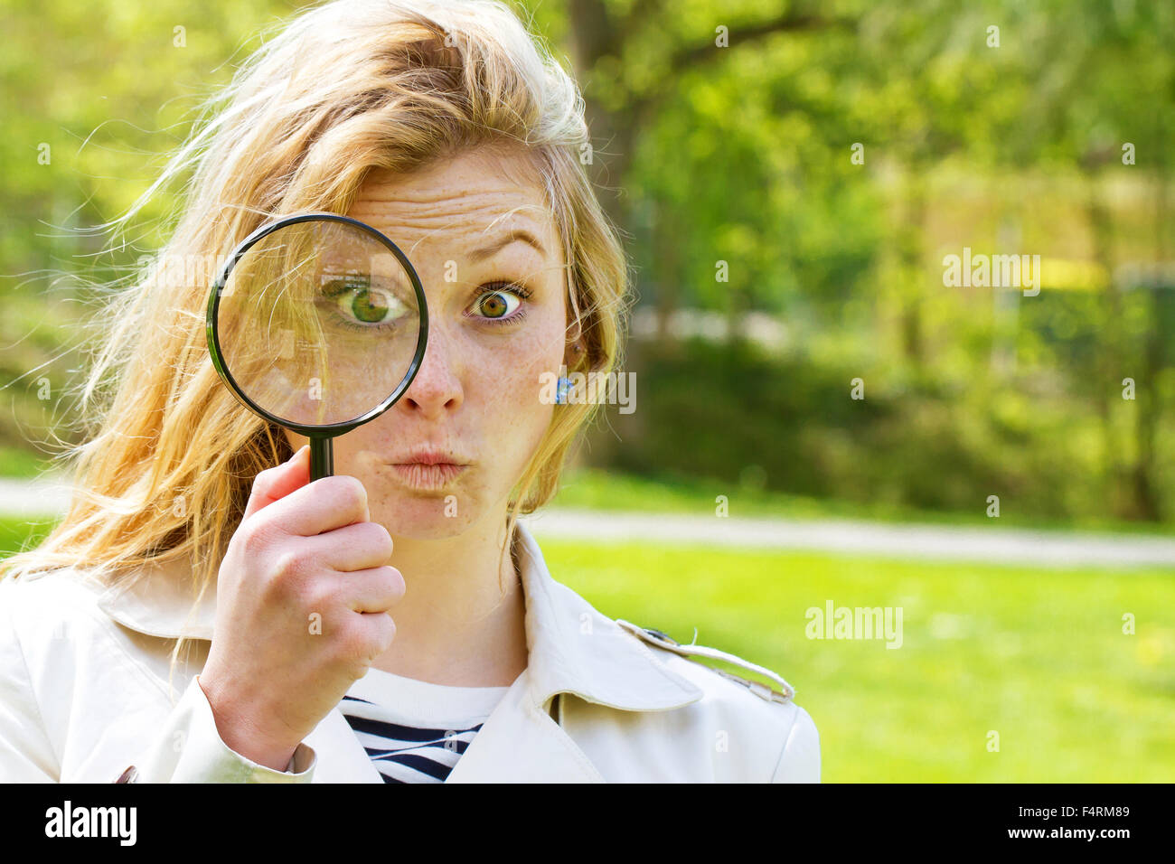 Woman with magnifying glass Stock Photo