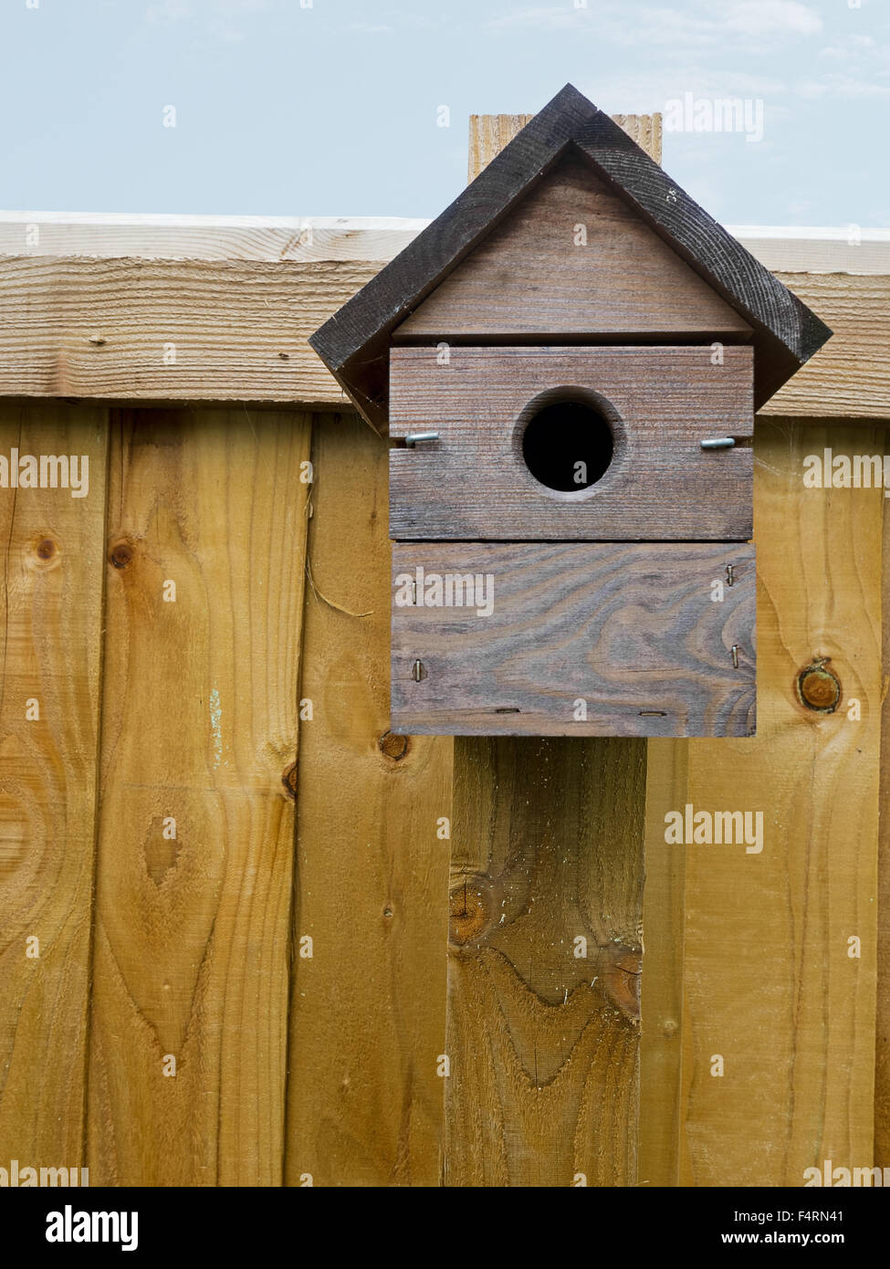 Bird nestbox on fence Stock Photo