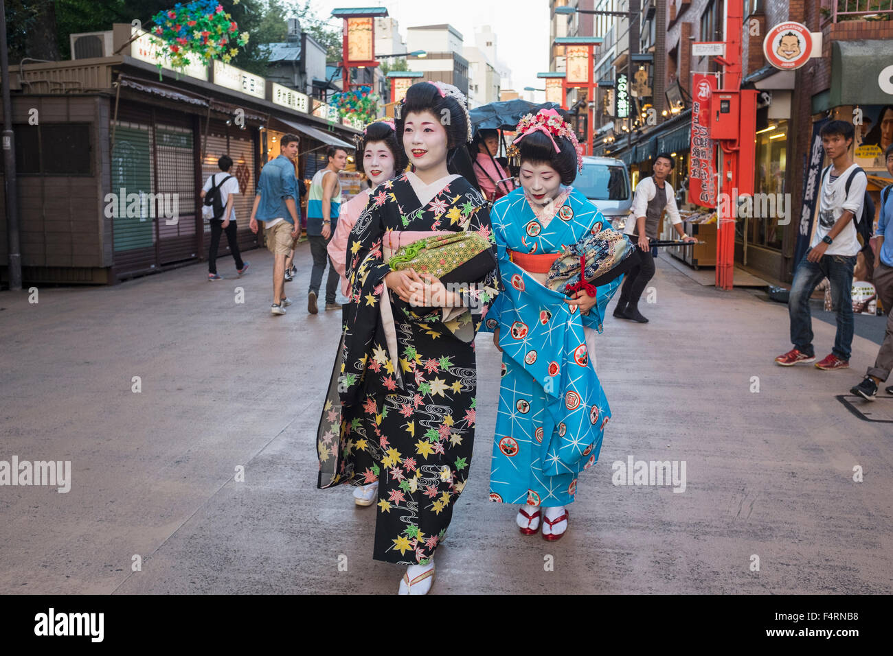 Three Geisha walking on Dempoin Street to engagement in Asakusa district of Tokyo Japan Stock Photo