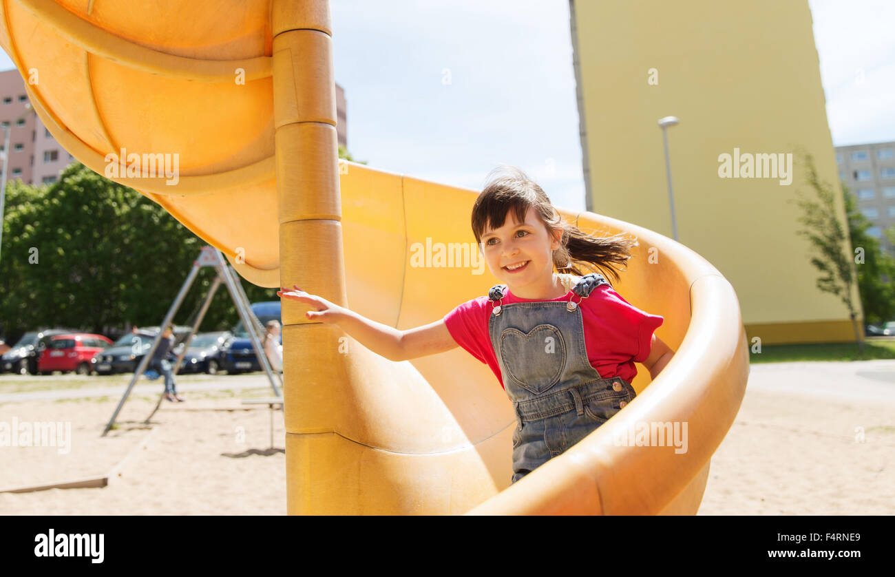 happy little girl on slide at children playground Stock Photo - Alamy